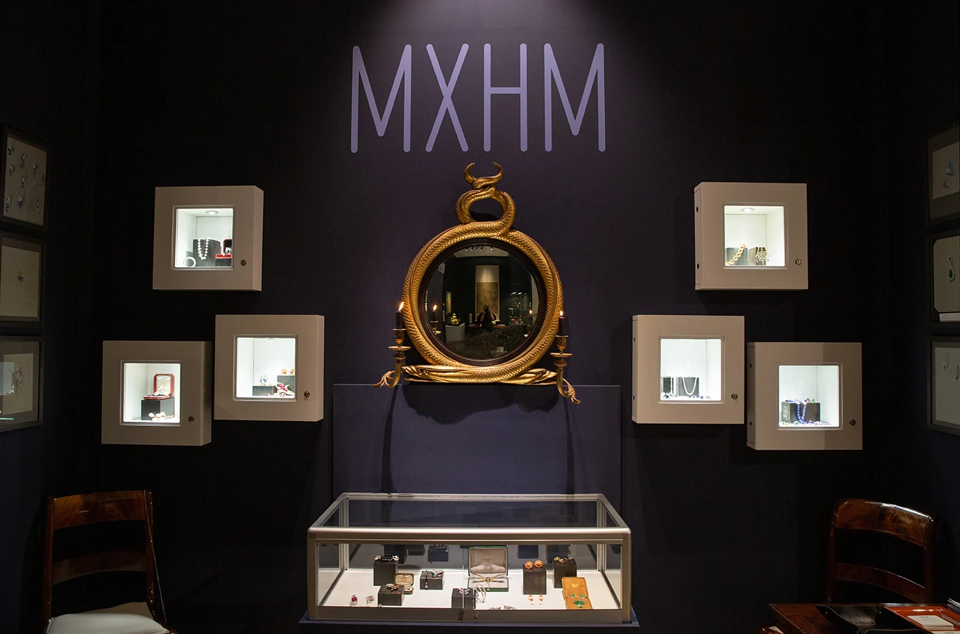 The MXHM stand at Munich Highlights: display cases, serpent mirror and wordmark