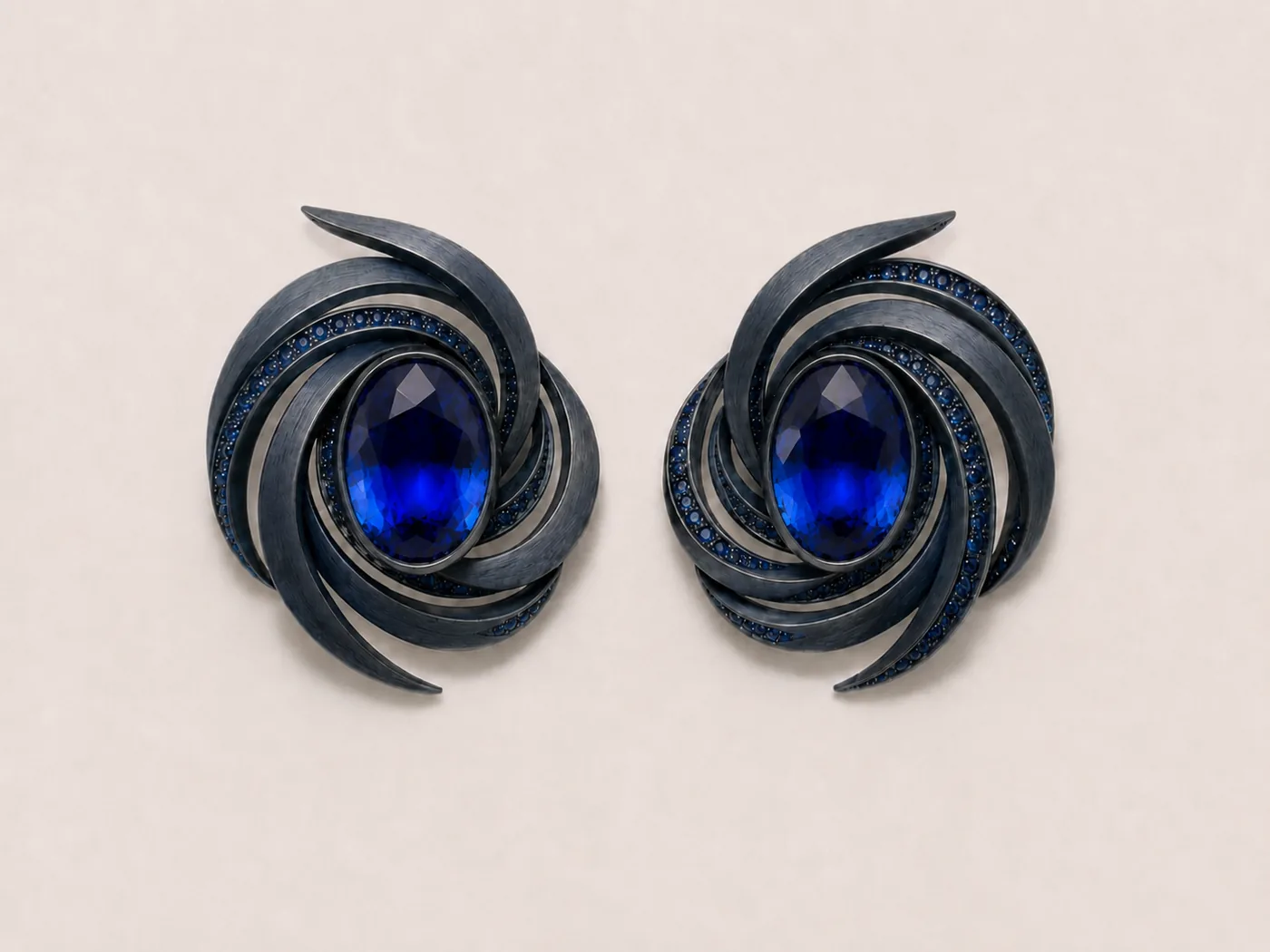 Gouache design: ear clips with curved spiral arms around an oval sapphire
